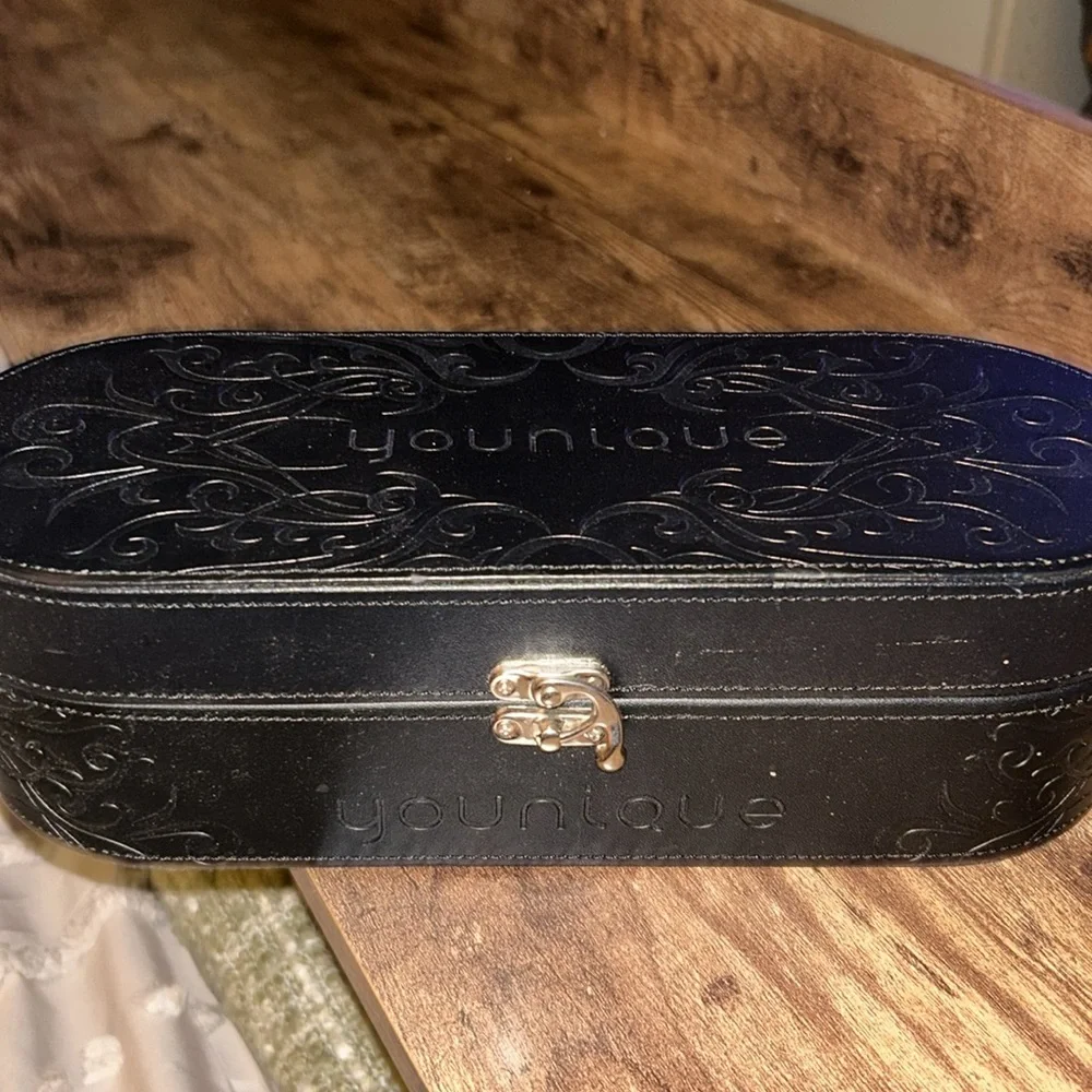 Younique black oval representative make up. Cosmetics case beautiful on vanity